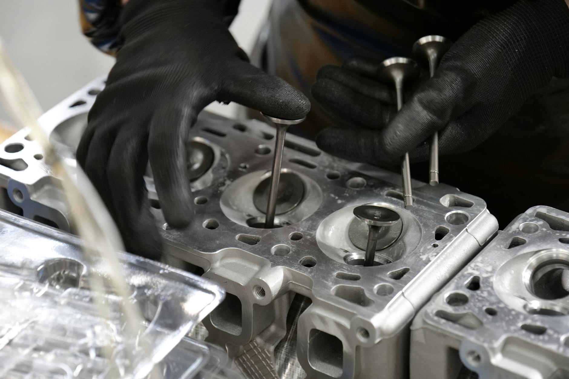 mechanic assembling engine cylinder head